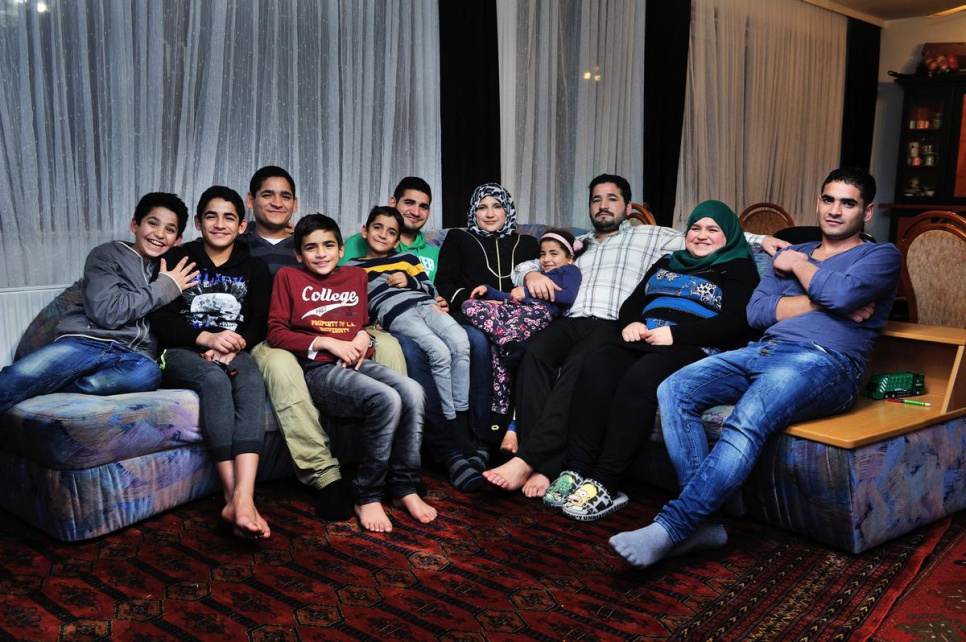 The Al Dayoub family relax in their new home. They are Bashar, Muhammed, Yousef, Abdel, Munther, Adham, Izdihar, Thuraya, Ameen, Samira and Ayman.