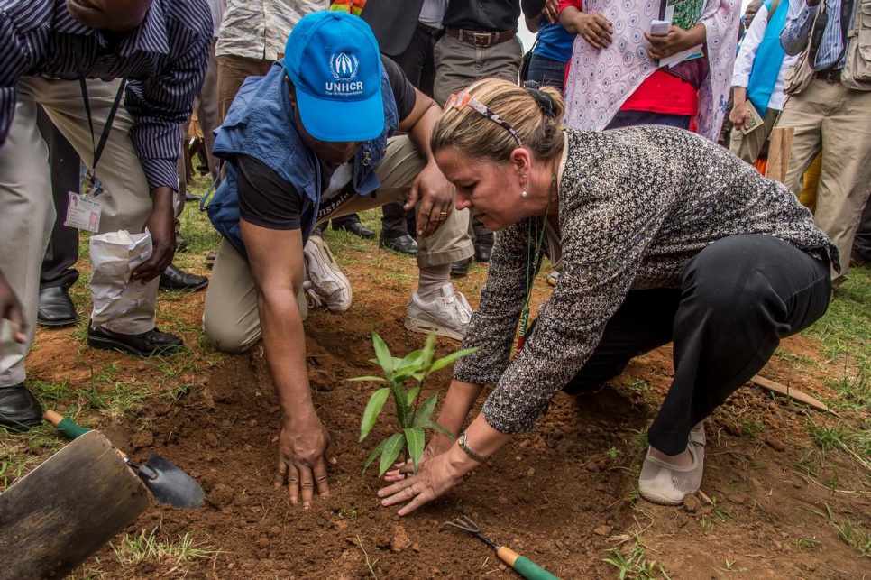 Deputy High Commissioner for Refugees Kelly T. Clements plants a mango tree to mark her visit to Nakivale settlement.