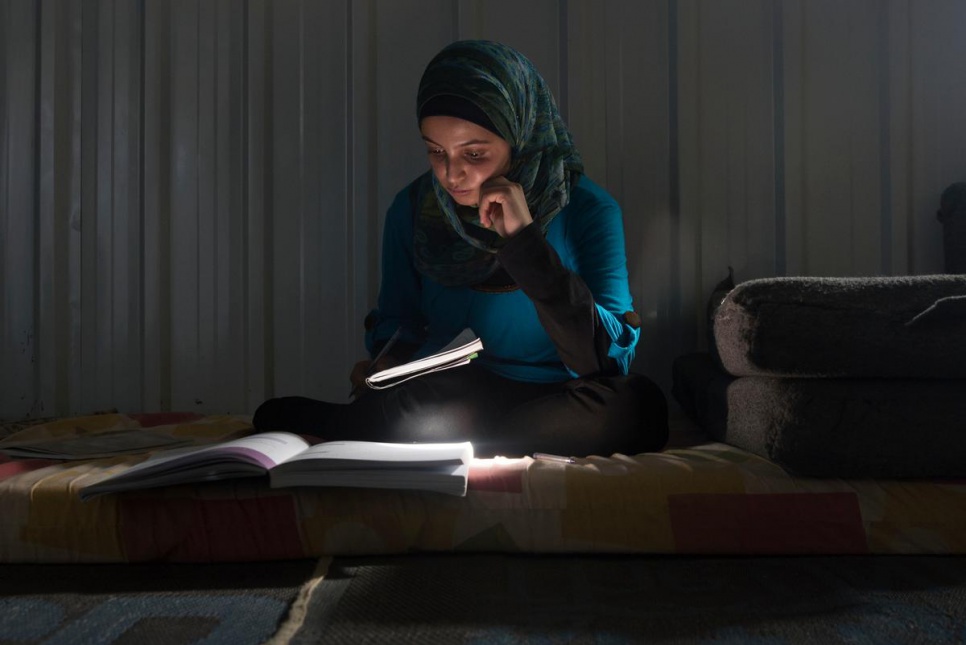 Muzon studies in her home at Azraq camp. "Our house was built by an engineer. When I was sick I went to a doctor. Education is everything in life," she says.