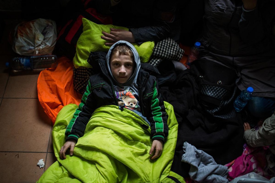 Ahmed, a seven-year-old refugee from Daraa, Syria, rests at a train station in Slanishte, FYROM, close to the border with Serbia.