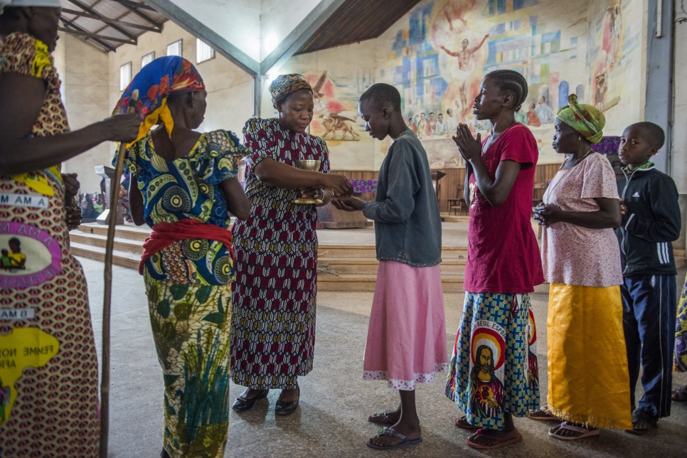 Sister Angelique, winner of the 2013 Nansen Award, gives communion at the Sunday mass in Dungu Cathedral.