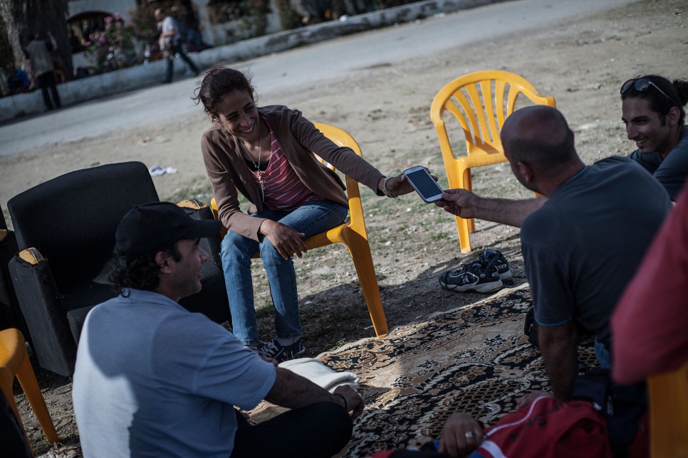 Nasreen chats with friends outside the defunct Captain Elias Hotel in Kos, Greece, where some Syrian refugees have found temporary shelter.