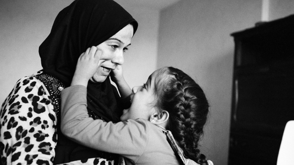 Aya with her mother Sihan in their apartment in France. When Sihan puts Aya to bed she whispers: "It's ok, this is your home now."