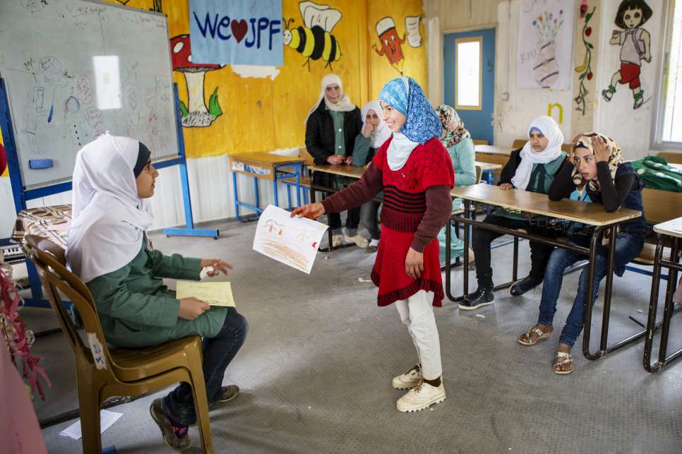 Omaima (left) raises awareness of the dangers that early marriage poses to her classmates at Za'atari refugee camp.