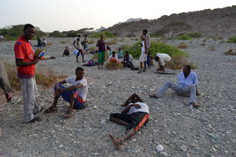 Exhausted new arrivals recover on the Al Hamra'a coast in southern Yemen. Smugglers often force their passengers to jump into deep water hundreds of metres from shore, for fear of being shot at by the coastguard. Many die because they cannot swim or are weak from the trip.