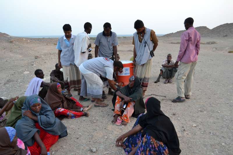 SHS provides water to a group of women recovering on the beach after the difficult journey from the Horn of Africa.