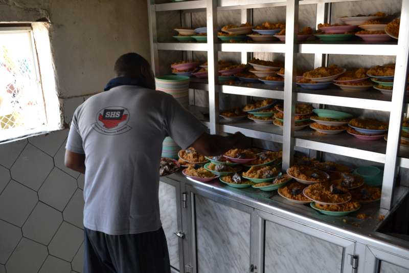 Plates of food are prepared for new arrivals in the Mayfa'a Reception Centre.