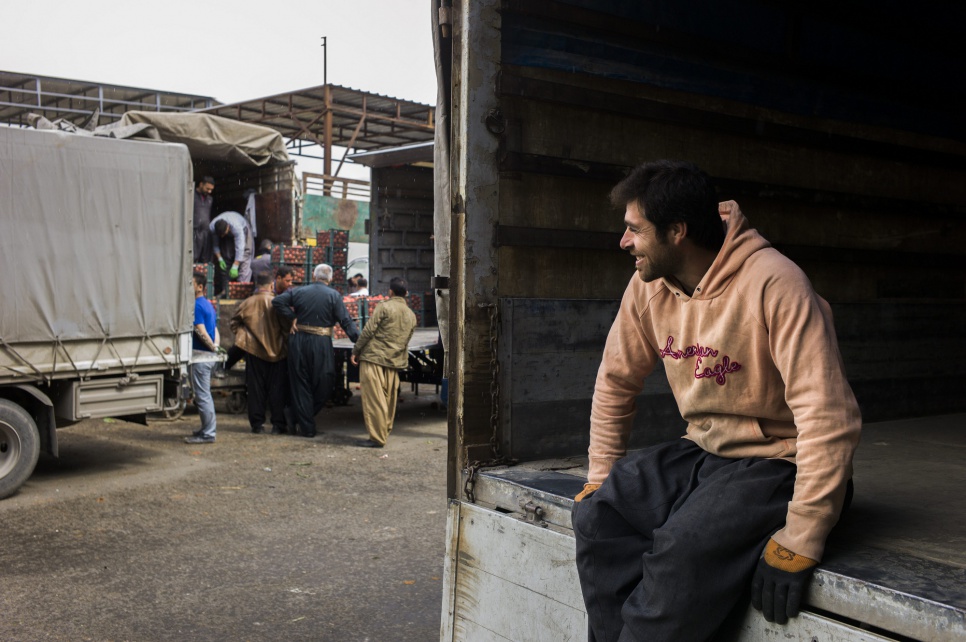 Ronak waits for the truck he is working on to pull up to the tomato seller. "It's so much better than in Syria," he says. "Here we have opportunities."