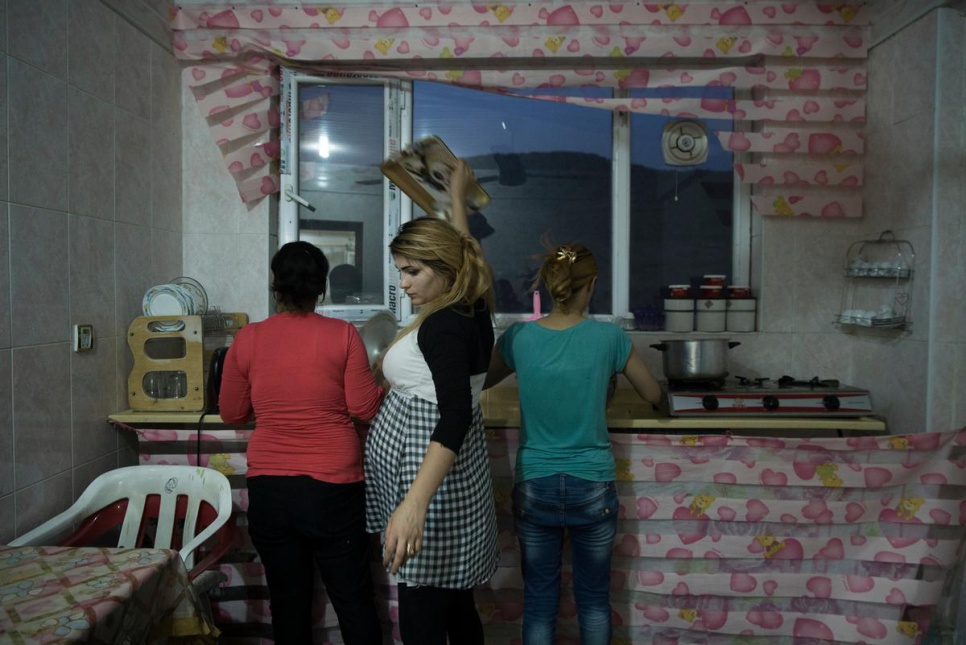 Syrian refugees from Qamishli wash dishes after a Ramadan iftar in Dohuk, KRI.