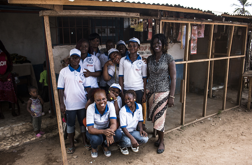 Liberia. Irene and her group of students stand outside of the training centre