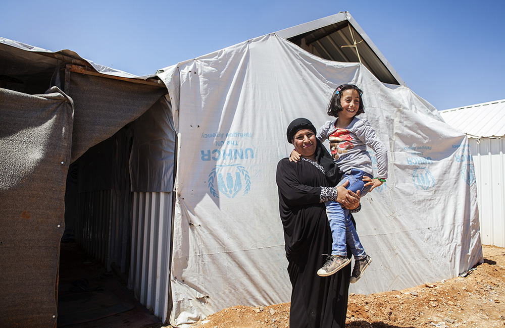 Jordan. Nine-year-old Syrian refugee, Solaf, with her mother Ruwaidah, 44, at Azraq refugee camp