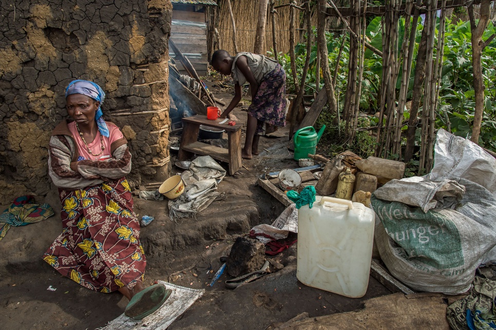 Many former residents of the settlement, including this woman and her daughter, are now sheltering in the courtyards of generous local residents.