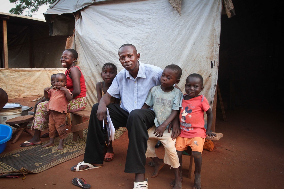 Before class, Gildas spends time with family members at a camp for displaced people in Bangui. The conflict has deepened his commitment as a teacher.