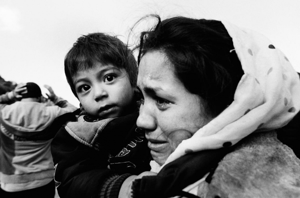 An Afghan mother hugs her child and cries with relief after arriving on Lesvos.