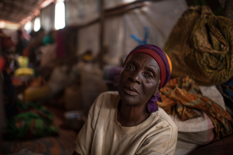 Foibe's mother, Elizabeth, sits down to rest shortly after their arrival at Nyarugusu refugee camp in Tanzania.