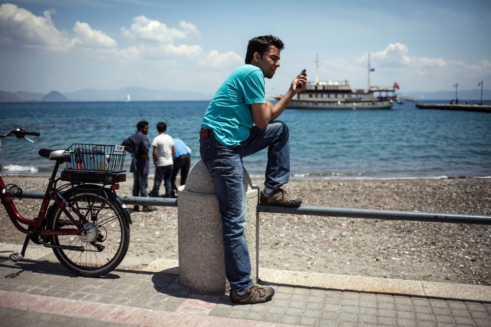 Ali passes time at the beach outside the police station in Kos, Greece. He is waiting to register with the authorities and travel to Athens.