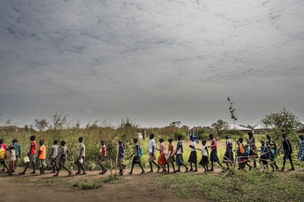 Students from Alaak's school head to the nearby water point to get a drink, a daily routine that provides a welcome break from the heat in northern Uganda.