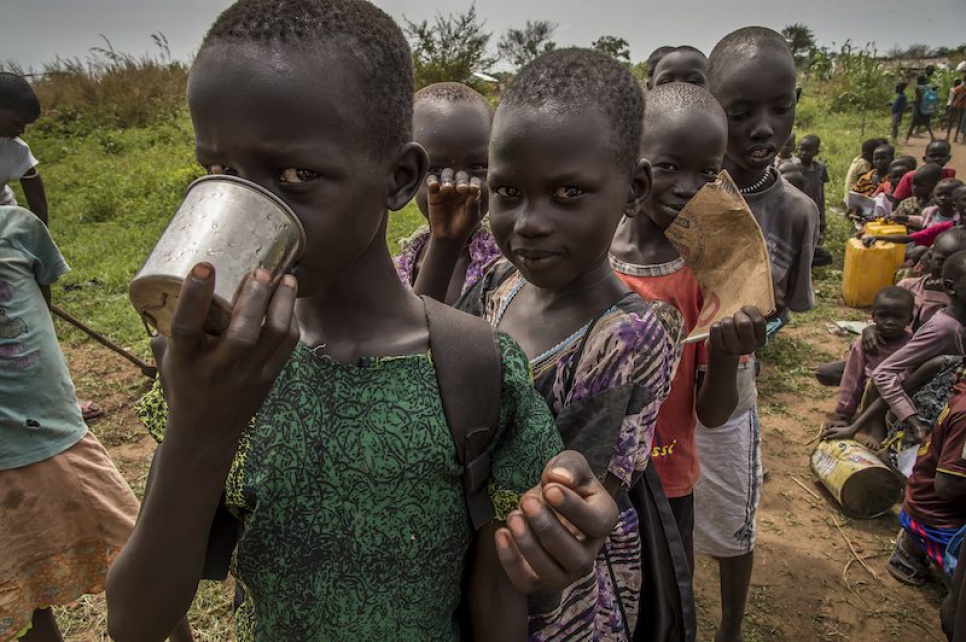 Alaak's students gulp down the water from a nearby hand pump at Uganda's Nyumanzi refugee settlement.