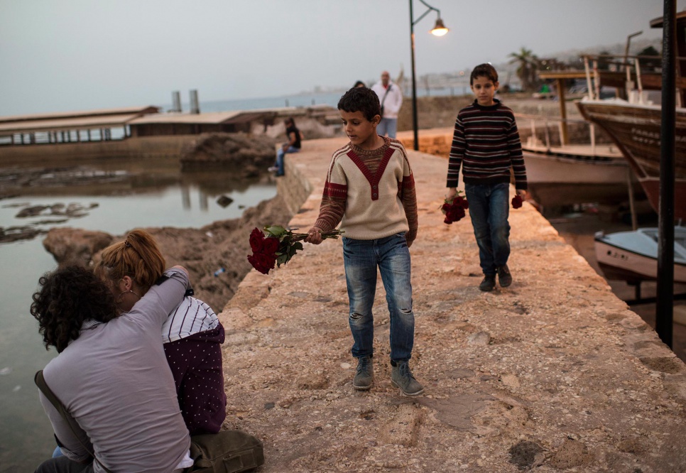 Manhal and Ahmed, 11 and 9, sell flowers by the sea in Byblos, Lebanon. They attend school, unlike their 13-year-old brother, Mohammed, who works seven days a week to help pay the rent.