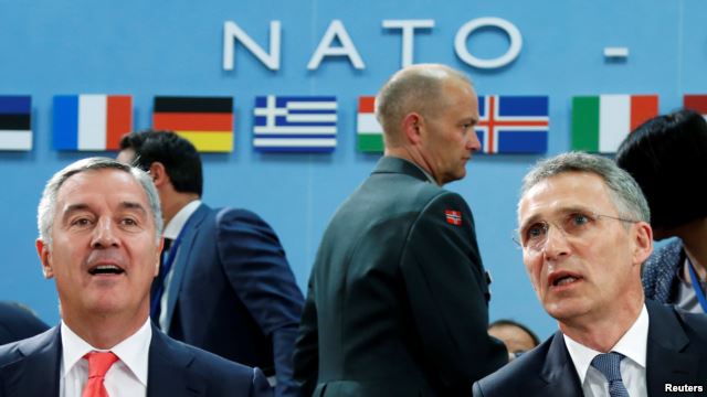 Montenegro's Prime Minister Milo Djukanovic (left) and NATO Secretary-General Jens Stoltenberg attend a NATO foreign ministers meeting at alliance headquarters in Brussels on May 19.