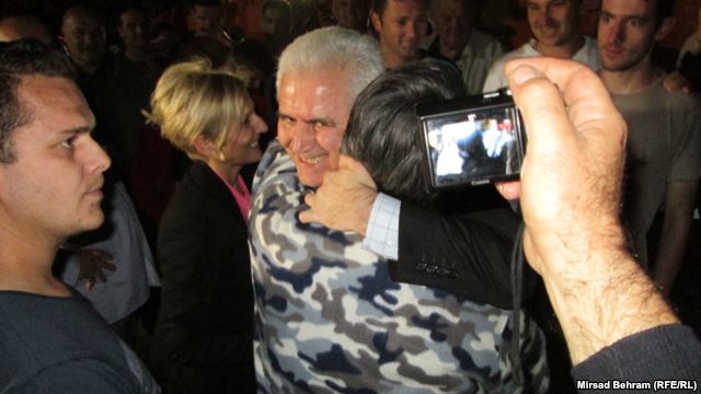 Zivko Budimir (facing camera, embracing a well-wisher after his release from prison in Mostar in May) and six other people are accused of arranging the pardons of 27 people without appropriate legal reasons to do so.