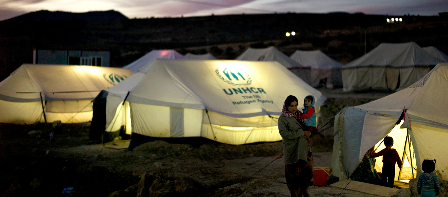 IDP's prepare for dinner next to UNHCR tents are lit from within after the sun has set in Zozan City IDP camp in Dohuk. Nights are already cold with temperatures can easily go below approximately 5C. In the coming weeks temperatures will drop below zero degrees.