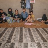 For large Syrian families, the spaces that they share often mean living in very close proximity to one another.In a former chicken barn in Mafraq, Jordan a collection of Syrian families have taken up residence.Although the building is old and the converted apartments basic, still each family must pay monthly around $250. The bathrooms and kitchens abbut one another and many people share the same sleeping rooms. / UNHCR / J. Kohler / August 2014