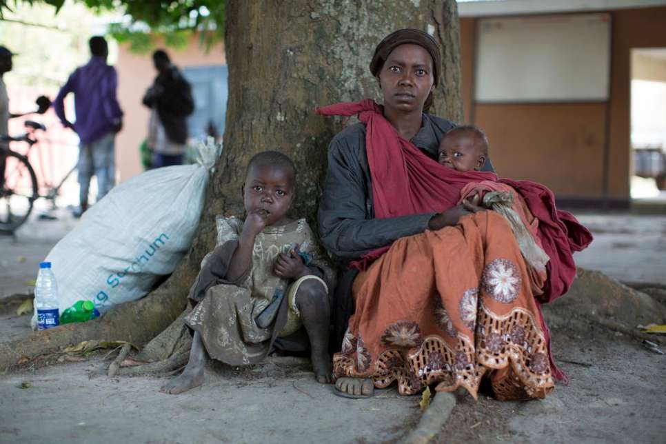 Congolese refugee Joyce and her children await to board a UNHCR truck heading to Makpandu, a camp 220 km east of Ezo, in South Sudan's Western Equatoria State. They fled war at home several years ago and found safety in this South Sudanese border town until clashes broke out between government soldiers and local armed youth in November 2015.
