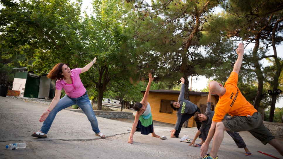 Efi Latsoudi practices yoga with three young refugees and instructor Konstantin, a volunteer from the United States.