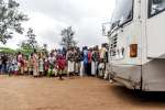 Burundian refugees waiting in front of a bus at the Bugesera reception...