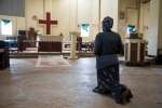 A South Sudanese woman prays at Emmanuel Cathedral compound in Yei, So...