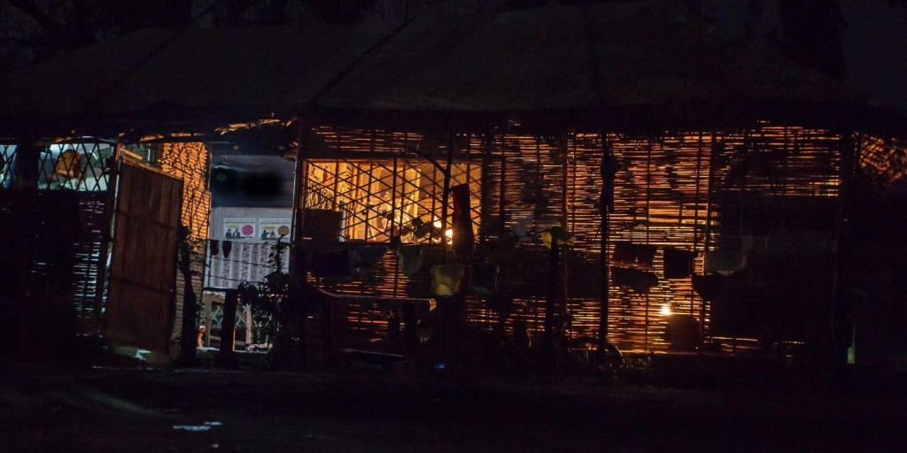 Soft light from kerosene lanterns and candles in Beldangi Refugee Camp.