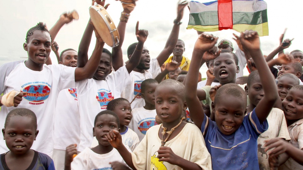 Young refugees from Central African Republic cheer as they watch capoeira at Mole camp.