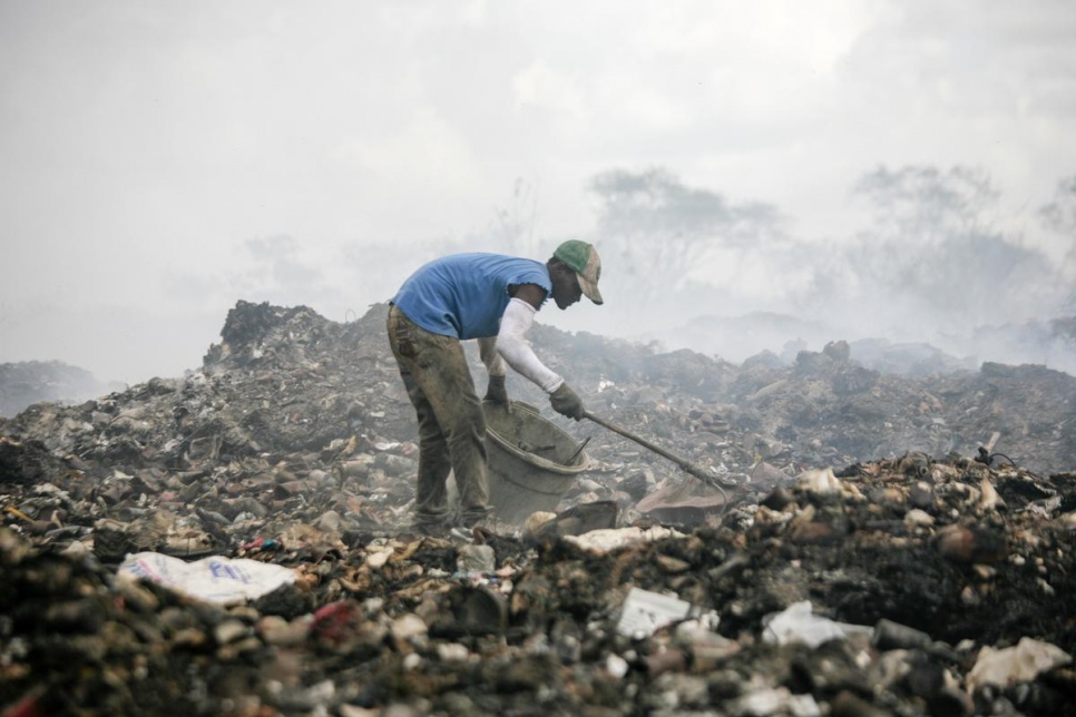 A man collects rubbish at San Pedro de Macoris municipal dump.
