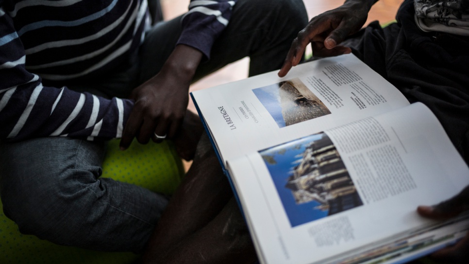 Manal, 16, from Darfur, reads a French geography book at a centre for unaccompanied children in Saint-Omer.