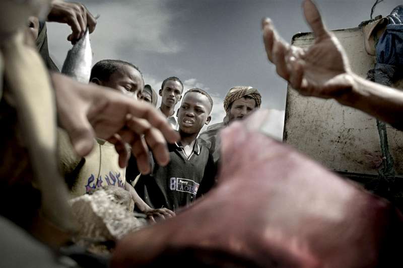 Somali refugees buy and sell fish in a small market in Kharaz refugee camp. 