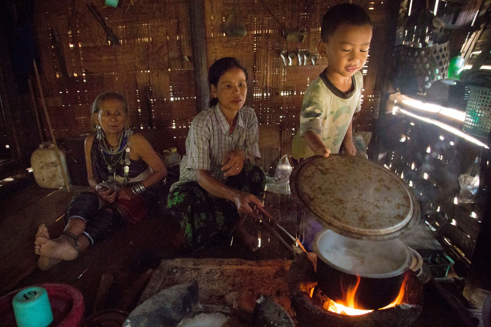 Now 75, Baw Meh fled Myanmar 18 years ago. Here she watches her daughter and grandson cook in Thailand's Ban Mai Nai Soi refugee camp.