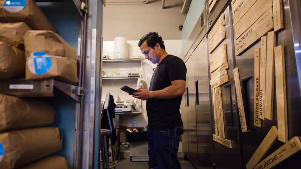 Samiullah Haidari checks stocks of coffee during his shift at Blue Bottle Coffee. 