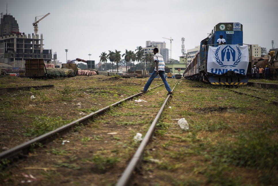 A train carrying hundreds of former refugees prepares to pull out of Kinshasa Est station in DRC. The passengers are embarking on a long journey home to Angola.