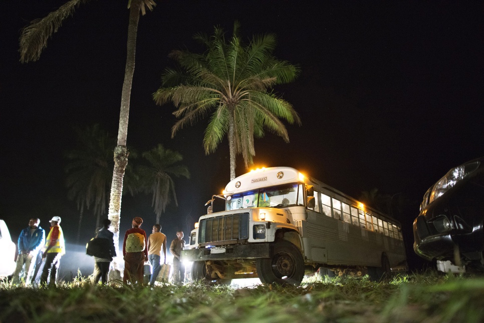 After Angolan authorities verify their documents, former refugees board a bus that will travel from Kimpangu, DRC, to the nearby Angolan border. It has been a long journey.