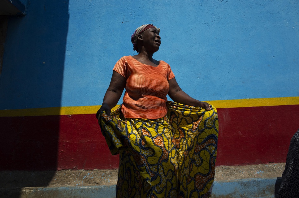 An Angolan woman waits at a collection point in Kinshasa, DRC. While everyone was excited to be returning to Angola, they were also sad to leave their adopted homes in DRC.