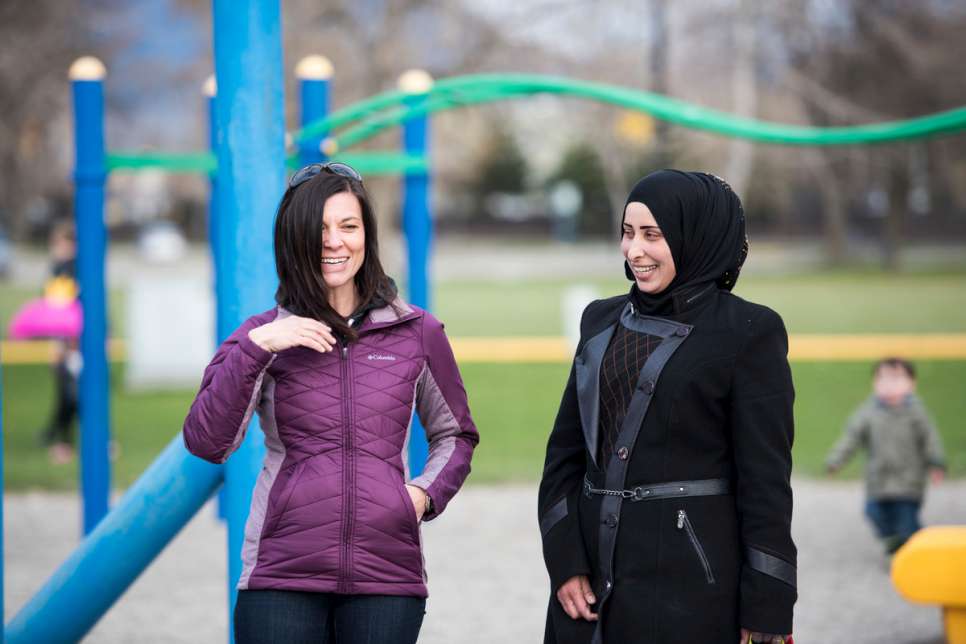 A Canadian sponsor chats and laughs with Sahar during an outing to the park.