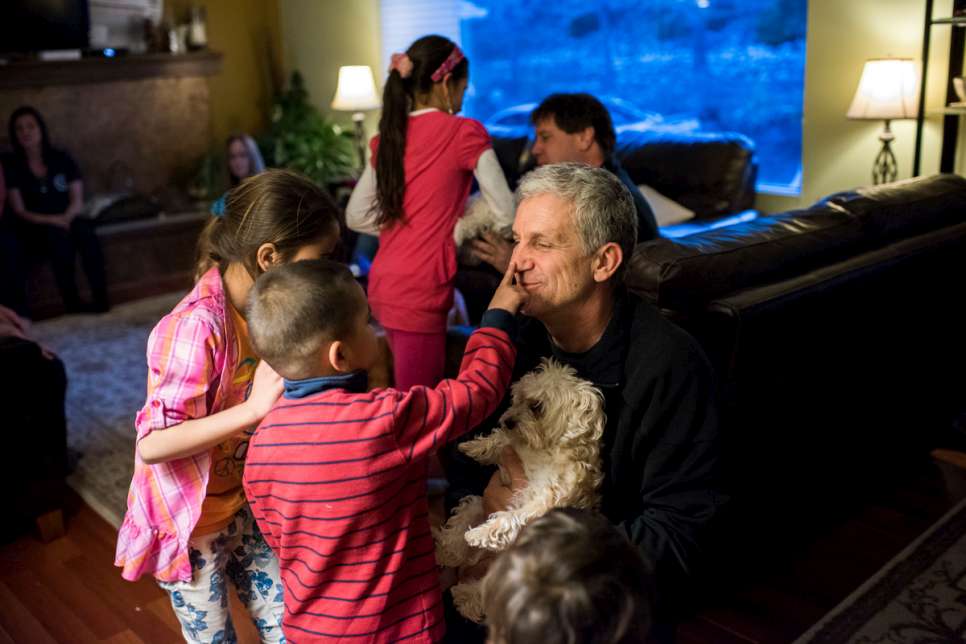Former refugee Emil Dimitrov brings his dog to play with Mohammad and Sahar's children.
