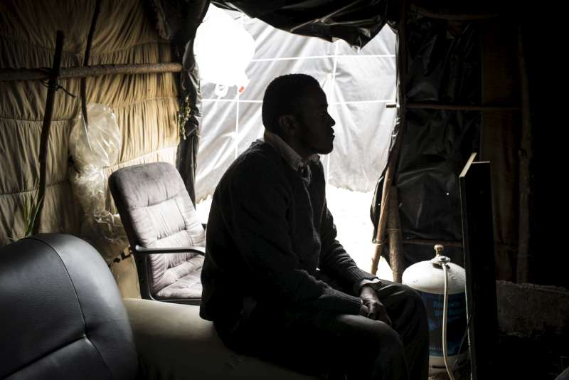 Farad, 26, a migrant from Sudan rests in his makeshift shelter in the so-called jungle in Calais. Farad wants to try to go to the UK, because he has family there and speaks good English. In England, he wants to study civil engineering.