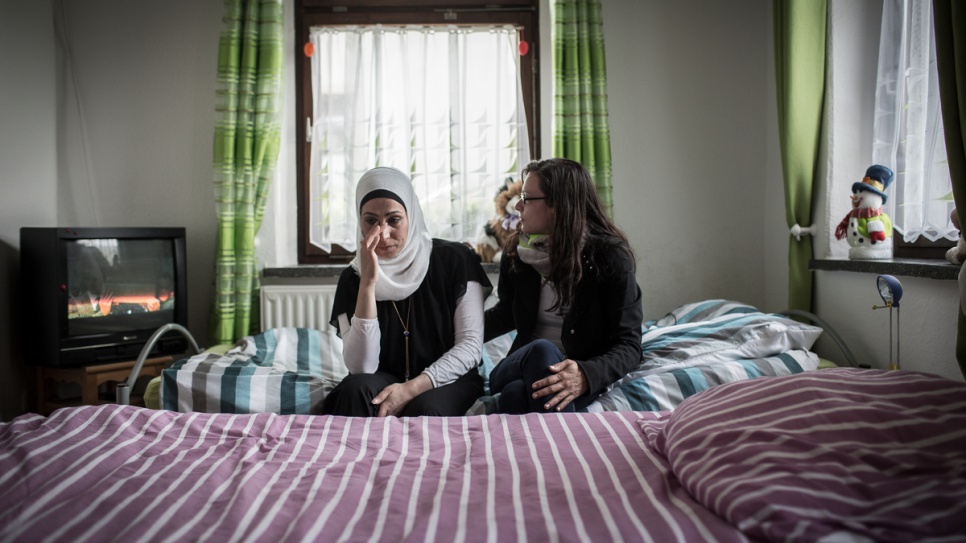 Layali Radwan is comforted by her landlord, Anna Polonko, in her small apartment in the German town of Thalheim.