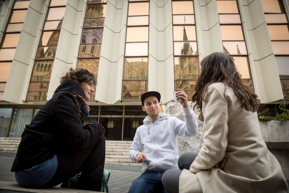 Mohamad does some card tricks for his Italian friends Miriam (left) and Nora. 