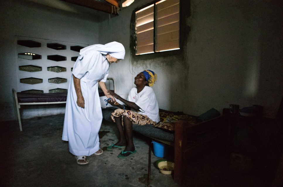 Sister Maria speaks with a patient at the hospital where she works as a midwife in Zongo, Equateur Province, DRC. The sister first arrived in Congo in 1959.