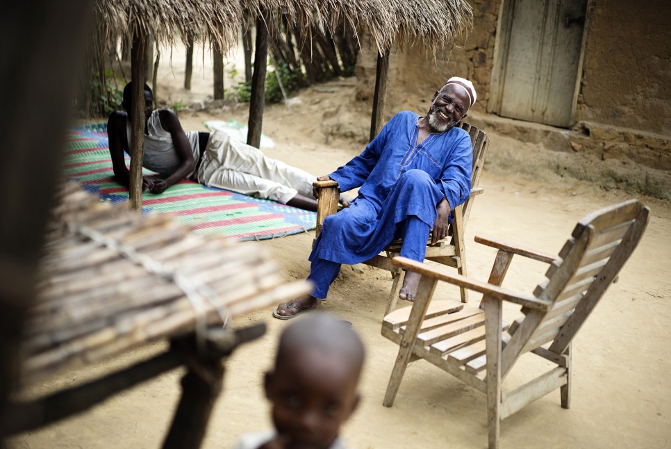Imam Moussa Bawa, 72, laughs at his home in Zongo, DRC. He works to promote peace and reconciliation among refugees in the area.
