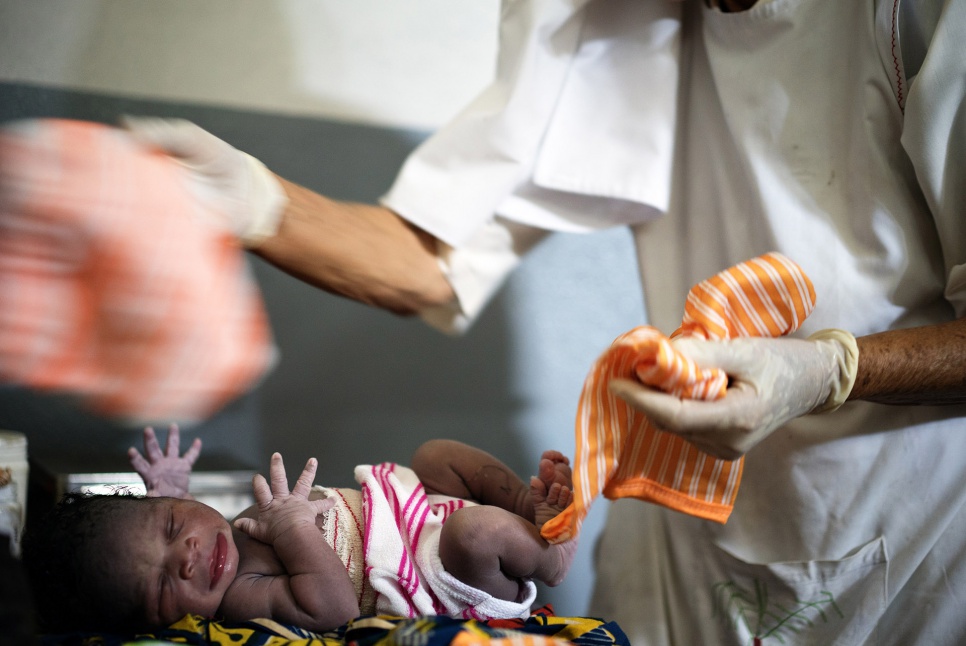 Sister Maria swaddles a newborn at the hospital her order operates in Zongo, DRC. She focuses on helping sick refugees gain access to treatment and sending refugee children to school.