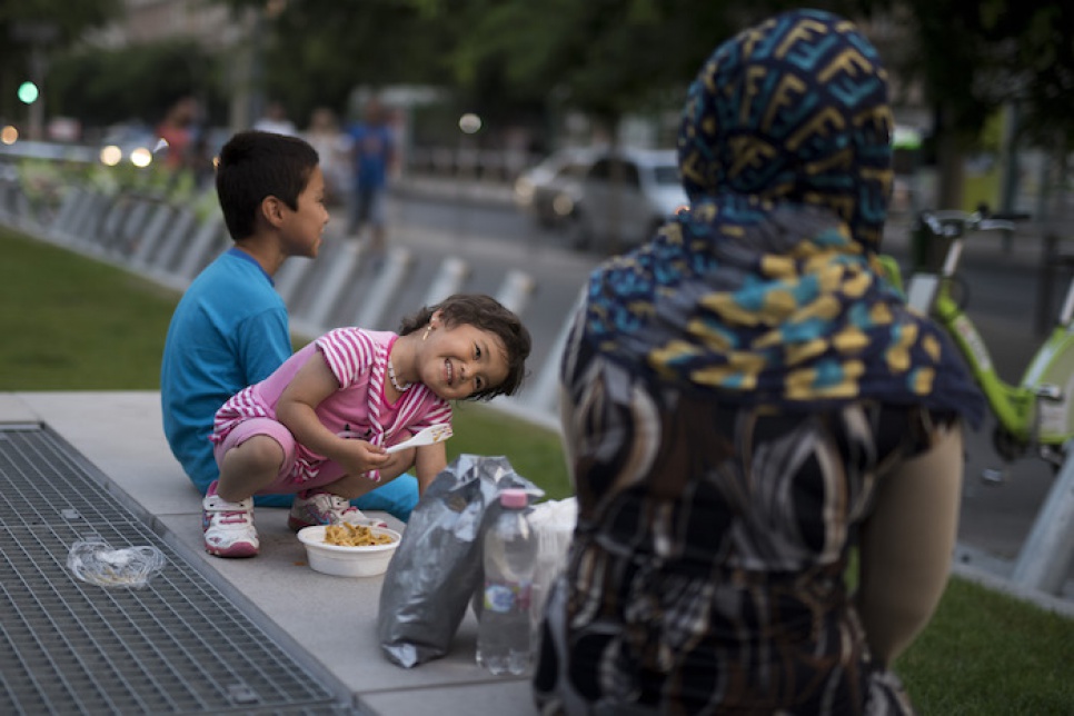 A moment of joy and relief for an Afghan family after receiving food from Hungarian activists.